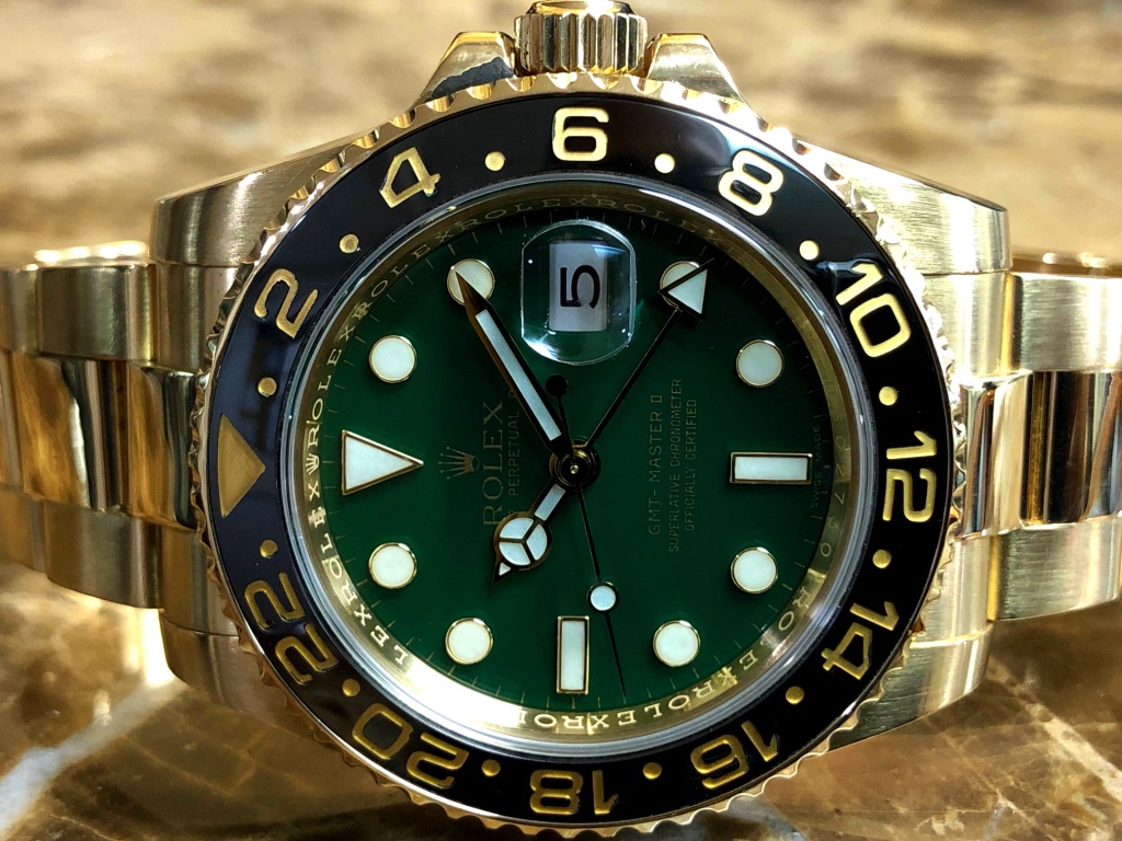 Rolex GMT Master II 18k Yellow Gold Green Dial Black Ceramic Box Papers 50th Anniversary | Sansom Watches, Rolex, Breitling, Omega, and more
