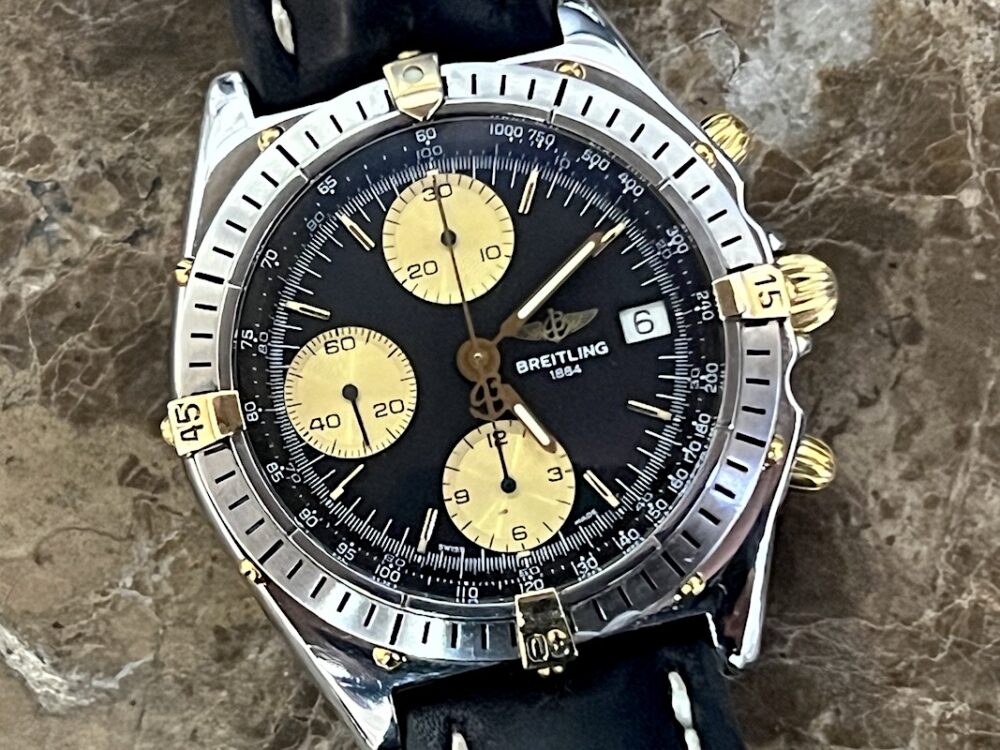 Breitling Chronomat 18k Gold / Steel automatic 40.5mm Black and Gold Dial Black Leather B13047