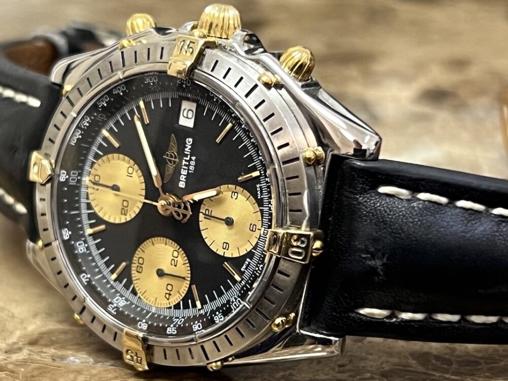 Breitling Chronomat 18k Gold / Steel automatic 40.5mm Black and Gold Dial Black Leather B13047