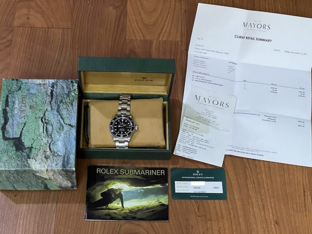 Rolex Submariner Date with Black Dial Black Bezel 40mm Automatic with Box and Rolex Service Card 16610