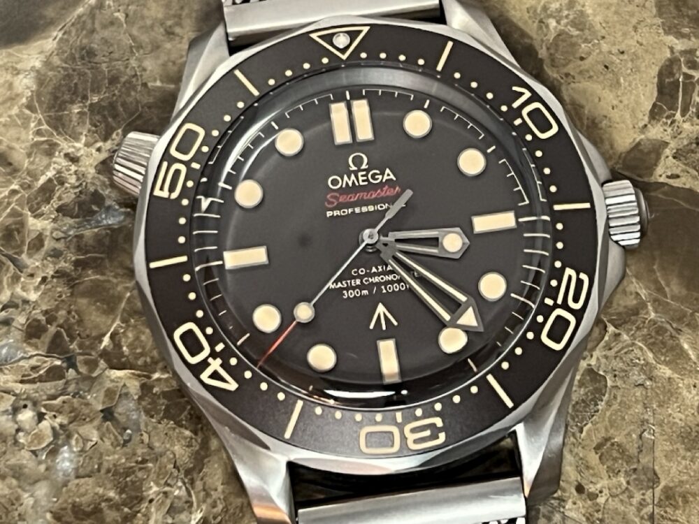 Omega SEAMASTER 300M 007 Edition Titanium Automatic 42mm Brown Dial Ceramic Bezel with Bracelet Box Papers Cards 210.90.42.20.01.001