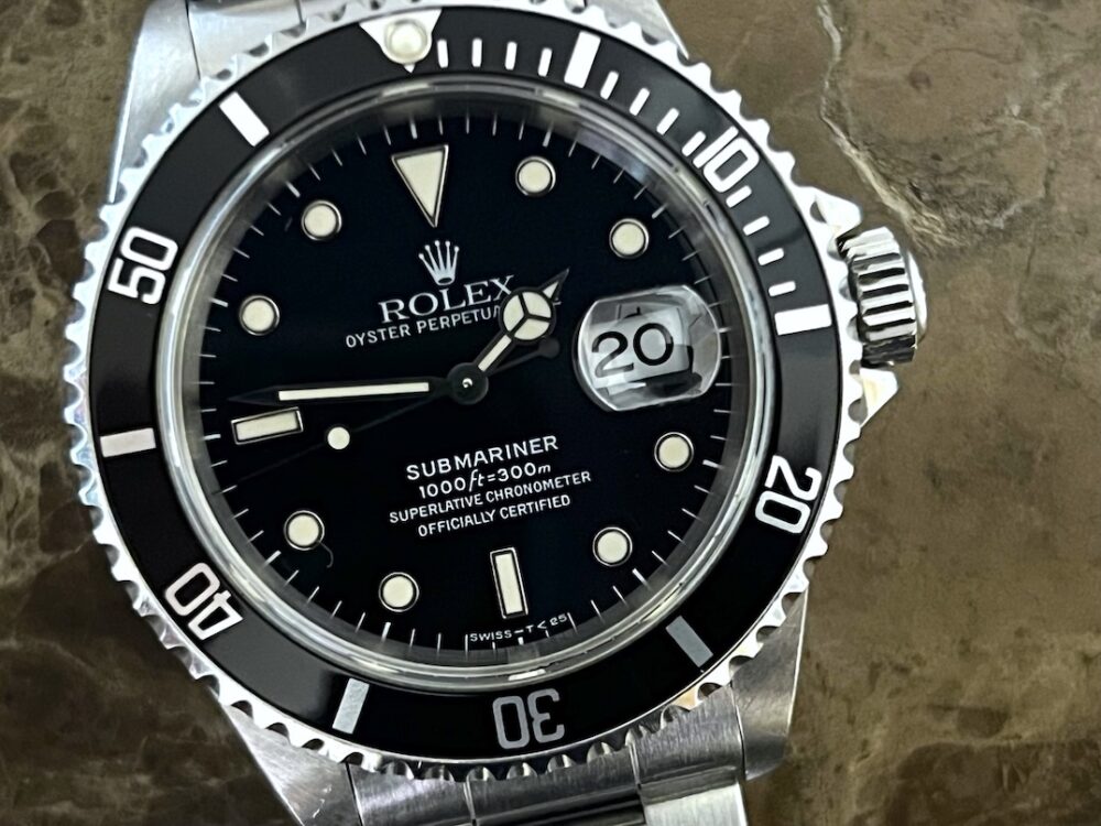 Rolex Submariner Date with Black Dial Black Bezel 40mm Automatic with Box and Papers 16610