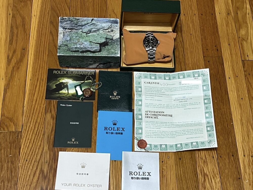 Rolex Submariner Date with Black Dial Black Bezel 40mm Automatic with Box and Papers 16610